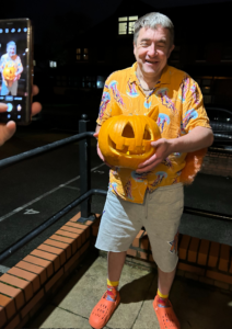 Andy holding a carved pumpkin