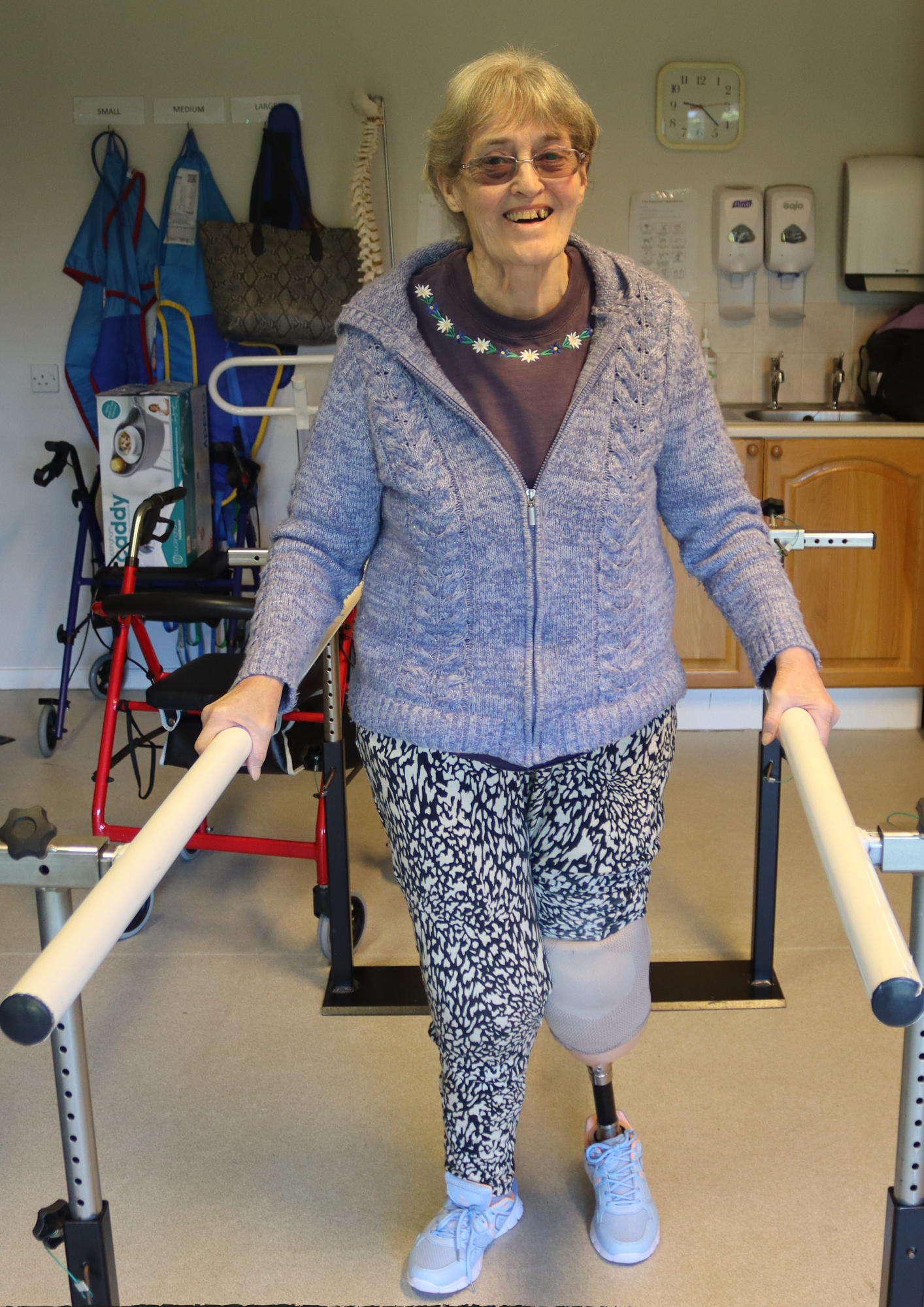 Christine smiling walking on her prosthetic leg.