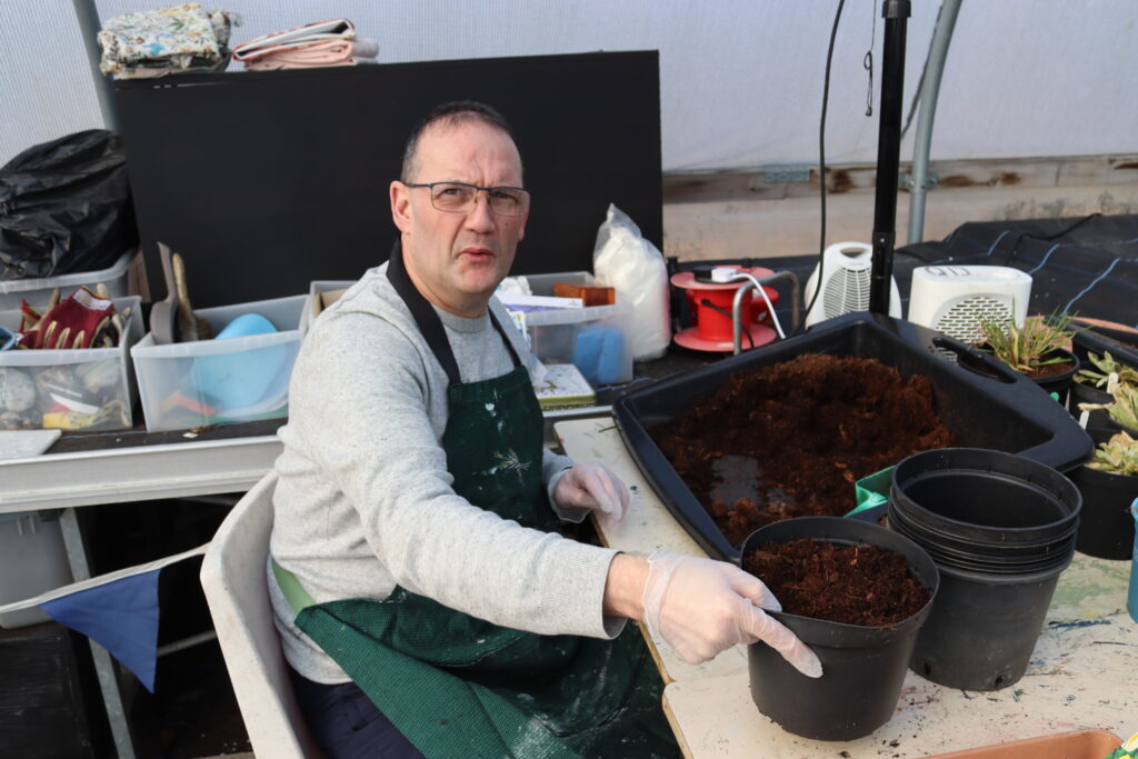 Man potting plants.