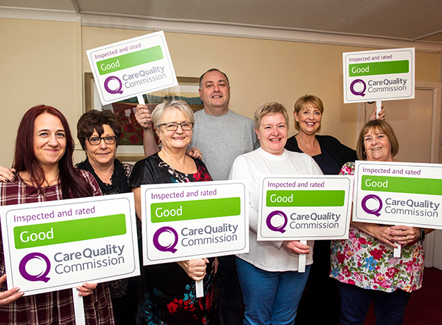 Aintree Lane workers holding signs with the rating: Good, Care Quality Commission