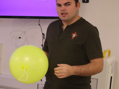 James standing holding a balloon