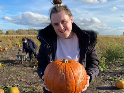 Hannah Holding a pumpkin