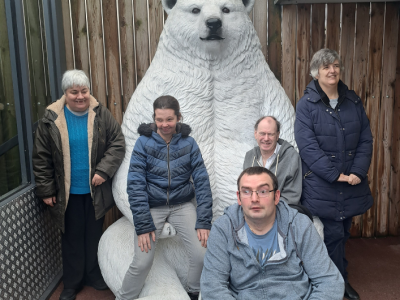 South Hub Members posing in front of a polar bear statue